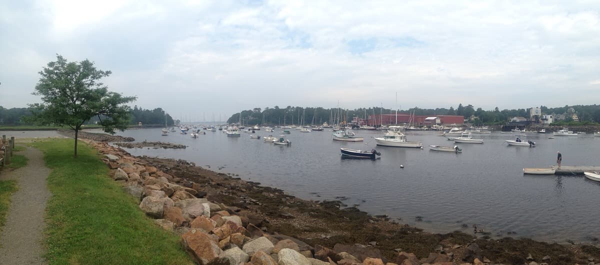 A small harbour with moored boats beneath a wide sky