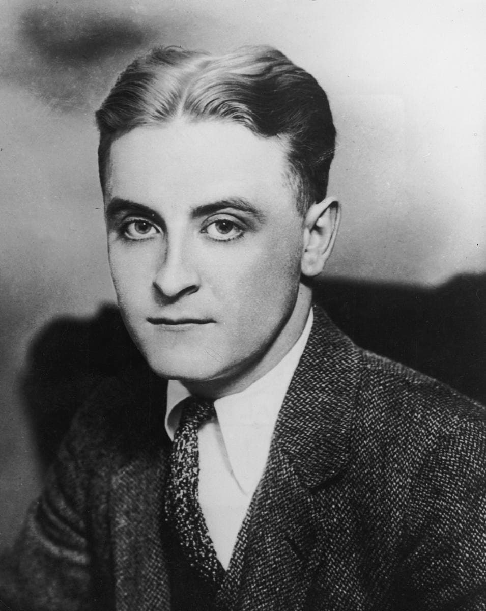 A black-and-white portrait of F. Scott Fitzgerald with slicked hair, in a tweed jacket