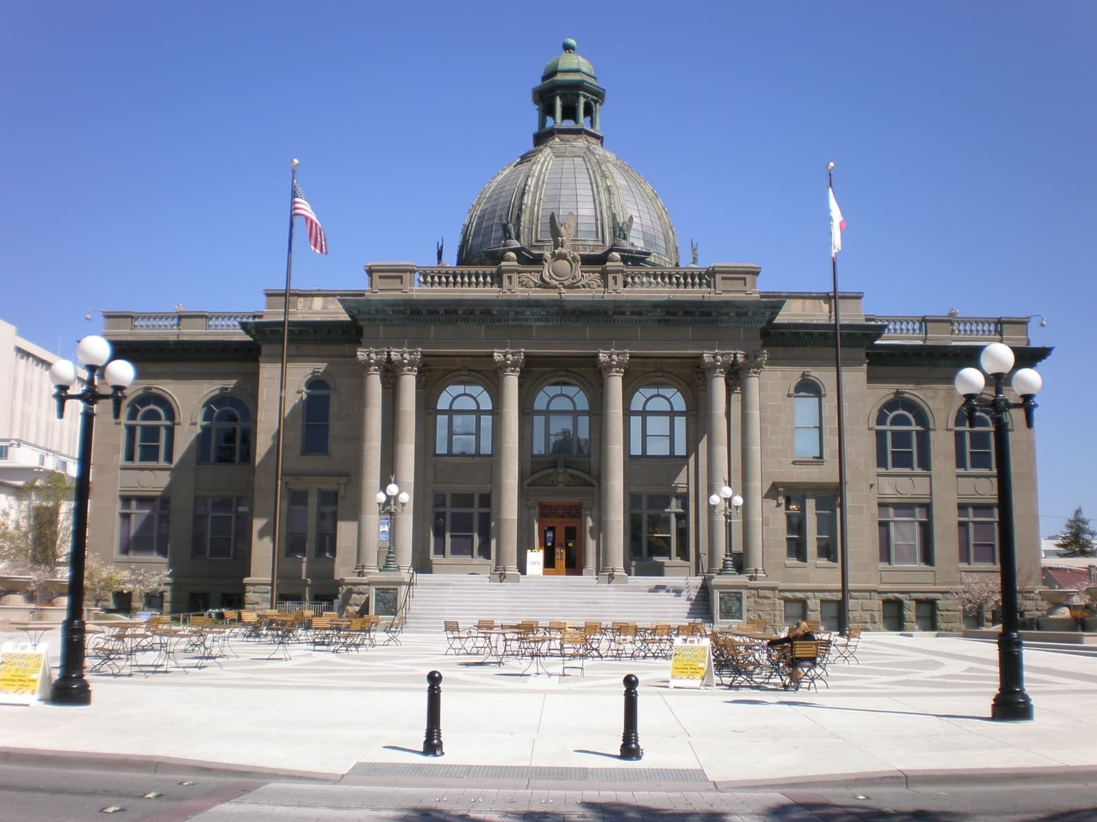 A domed neoclassical courthouse with columns and a plaza in front