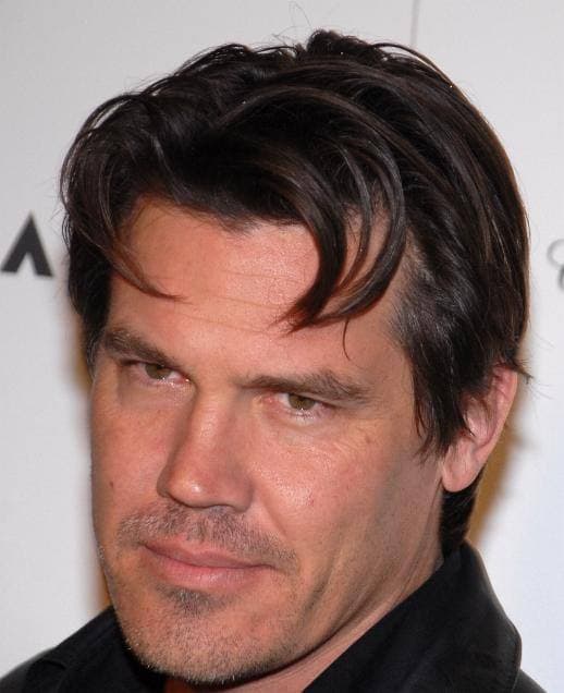 Josh Brolin, dark swept-back hair, looking at the camera