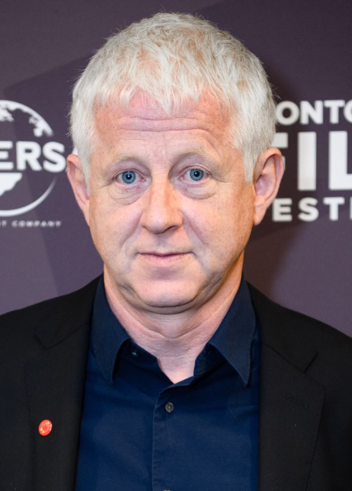 Richard Curtis in glasses, smiling
