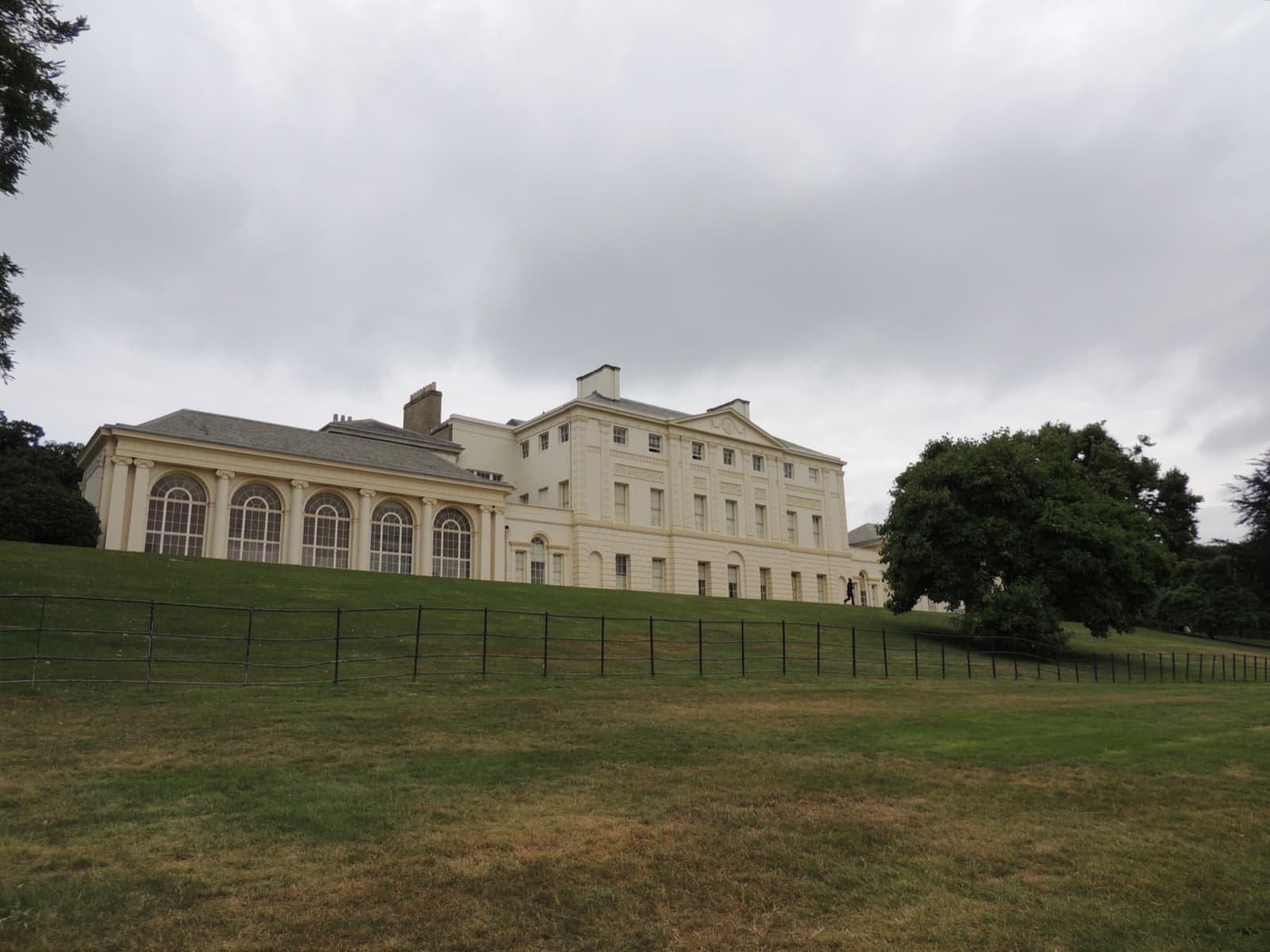 The white neoclassical south front of Kenwood House above a lawn