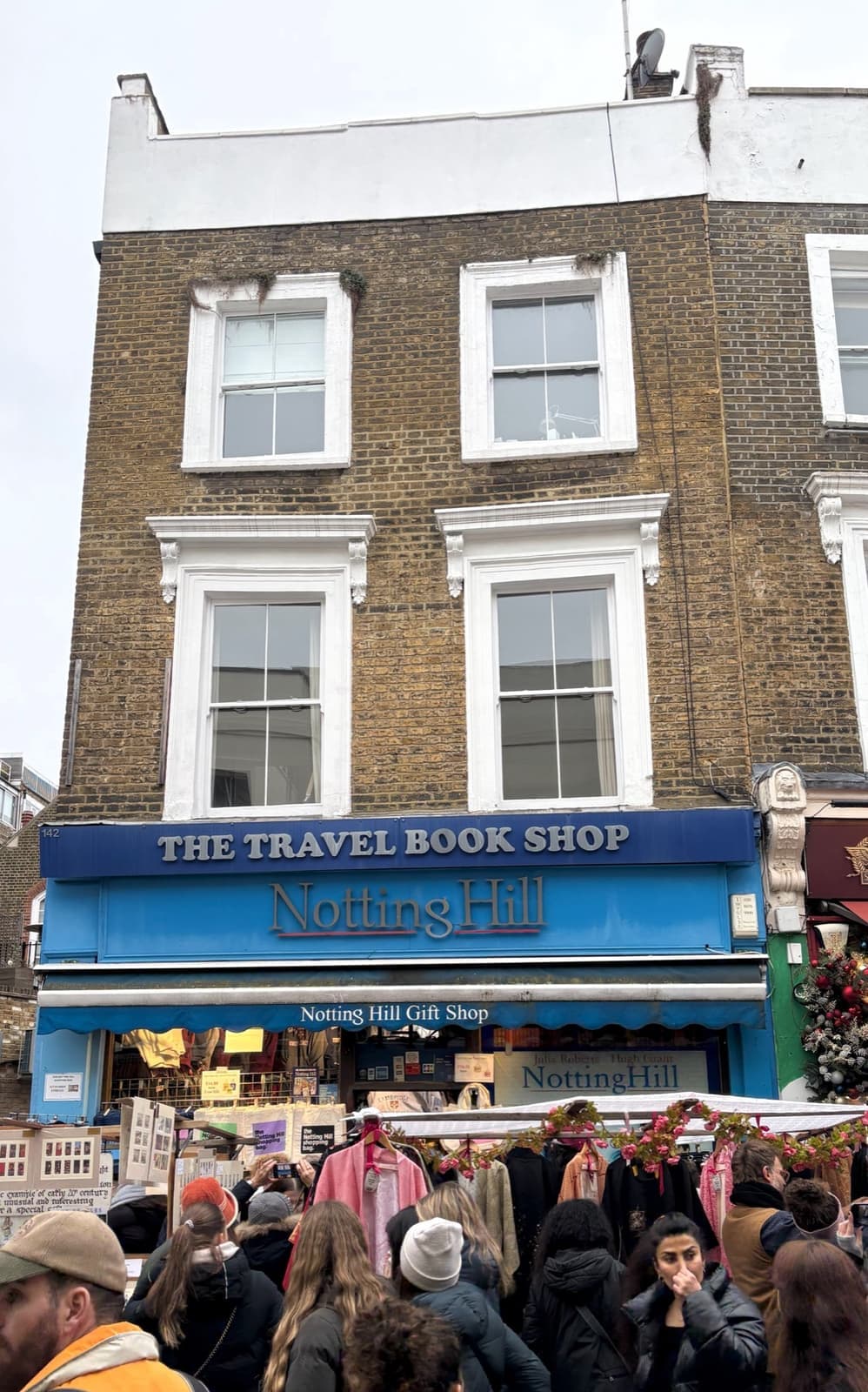 A shopfront on Portobello Road with a Travel Book Shop sign