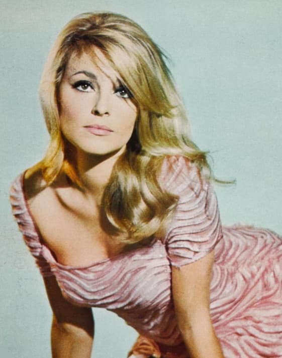 Sharon Tate in a pink top, her long fair hair over one shoulder