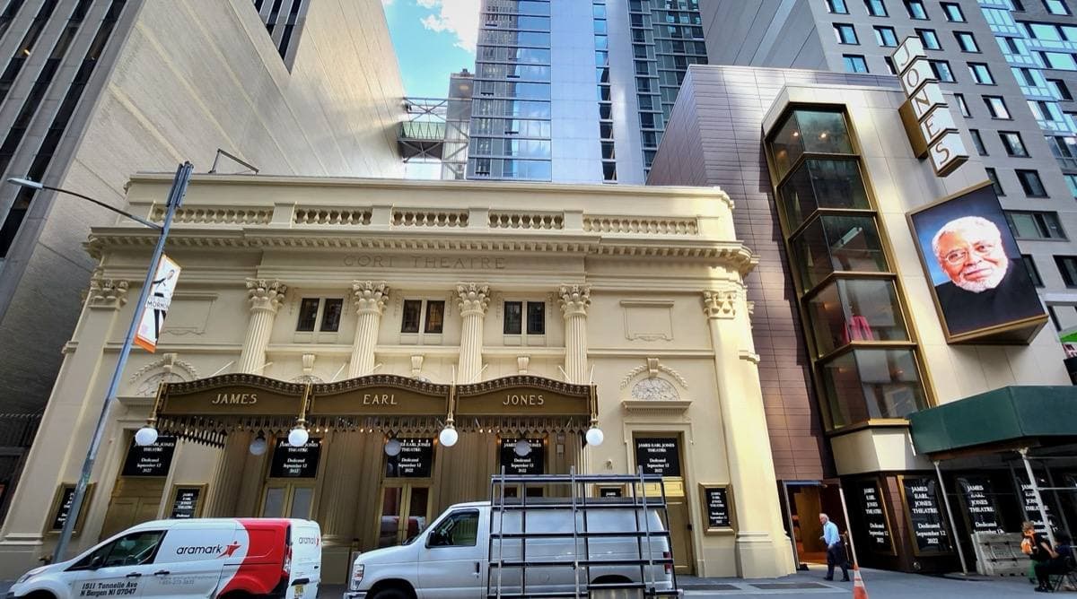 A white classical theatre front on a Manhattan street