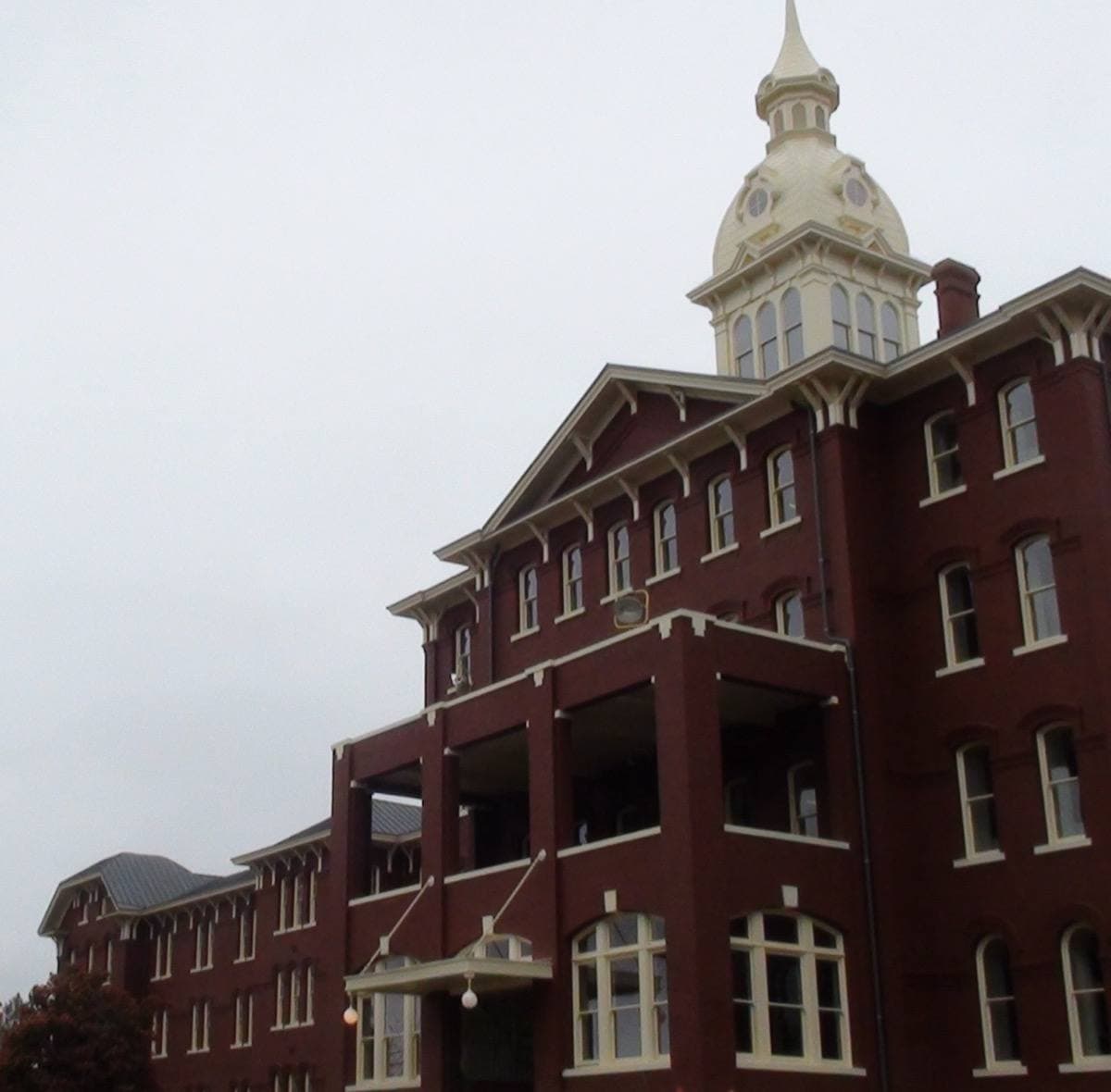 A white Italianate hospital building with a central tower
