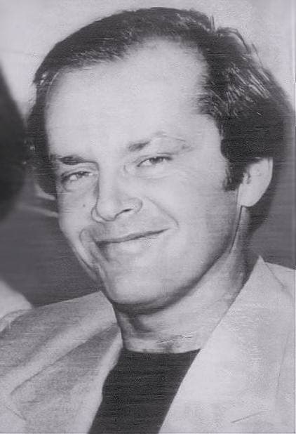 Jack Nicholson in 1976, smiling, in a pale jacket