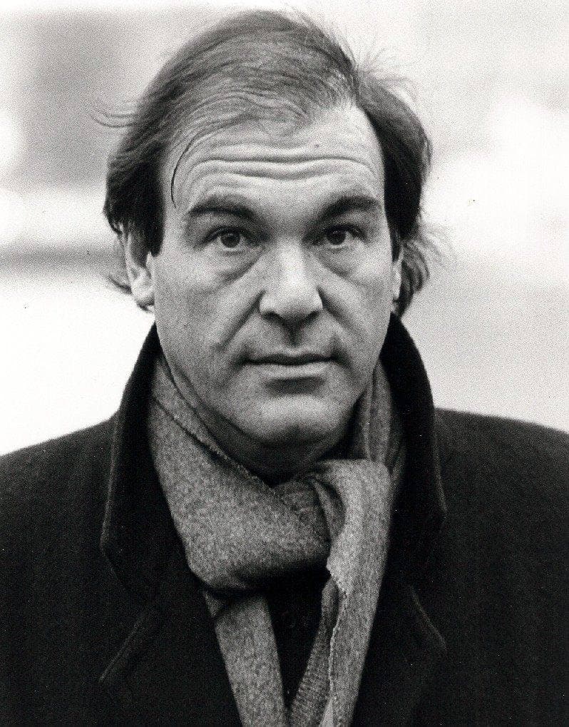 Oliver Stone in a dark jacket, looking to one side