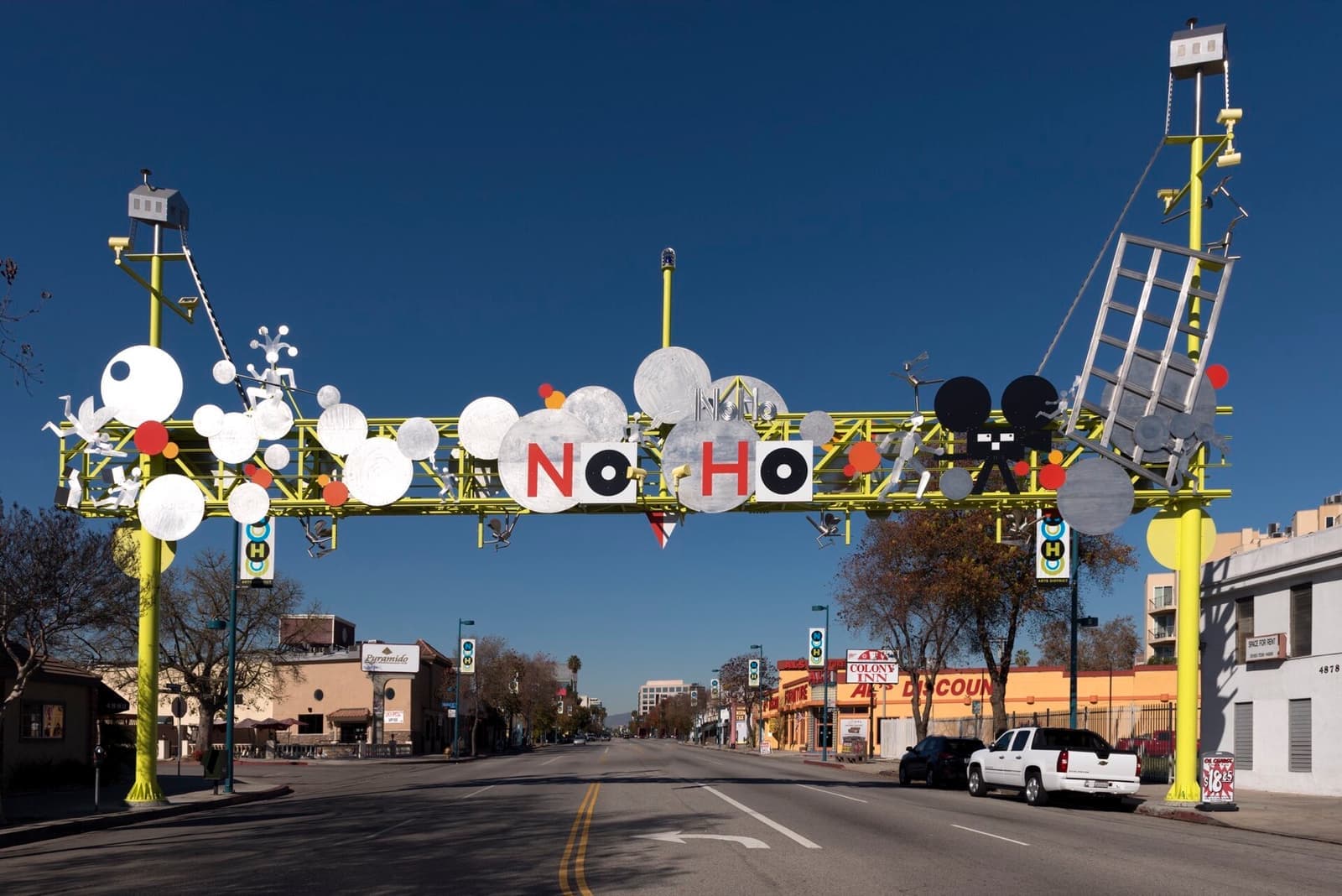 A sculpted arch spelling NoHo across a wide street
