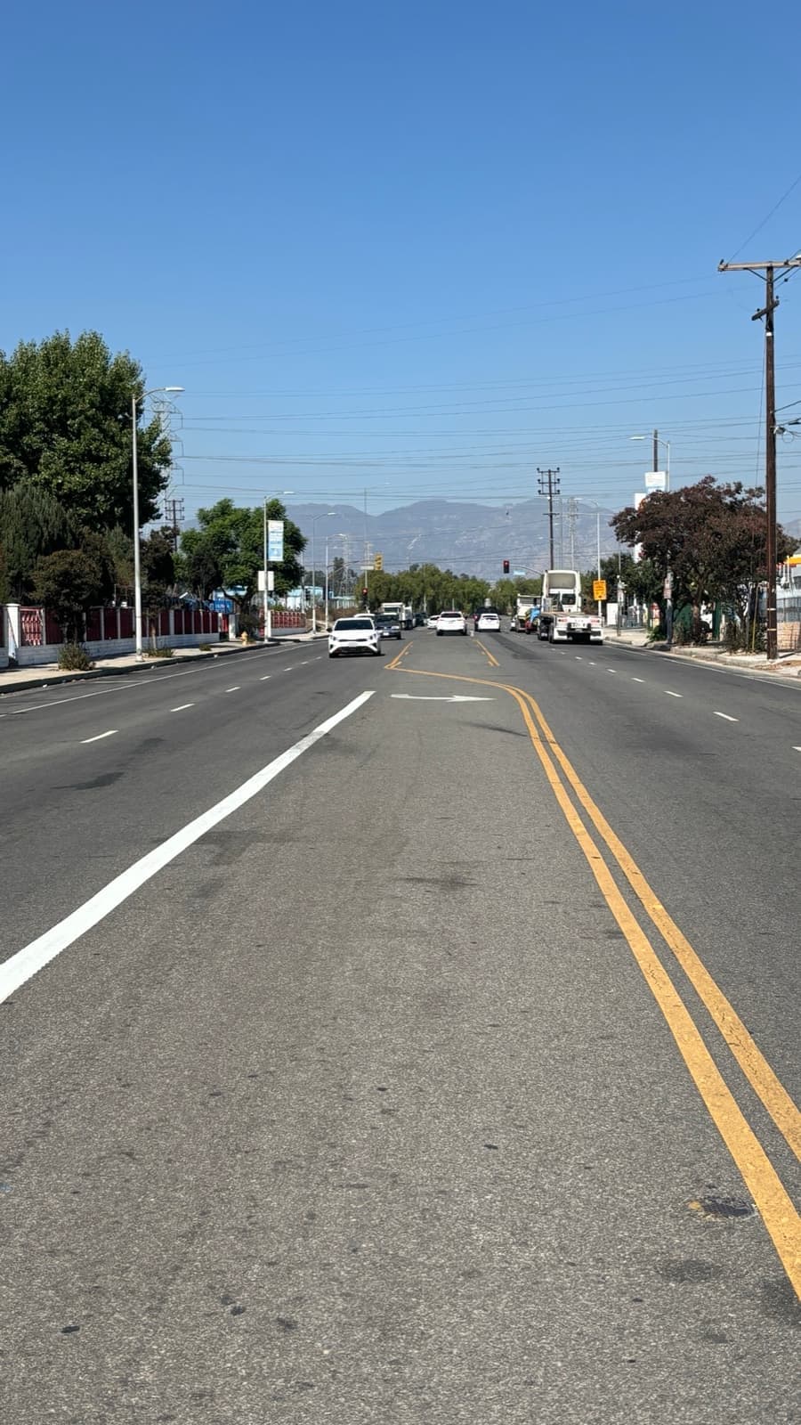 A long straight road under a blue sky