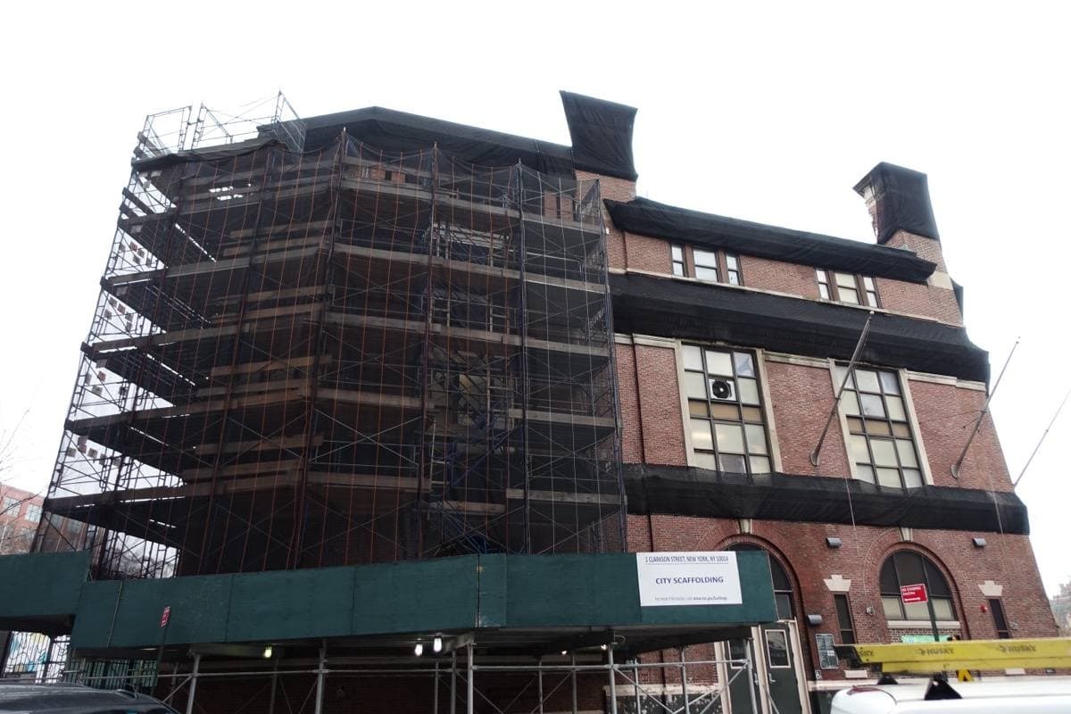 A red-brick recreation centre wrapped in scaffolding on a Greenwich Village corner
