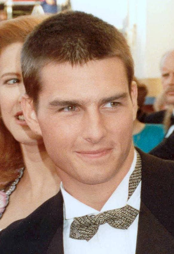 Tom Cruise in a dinner jacket and patterned bow tie, looking to one side