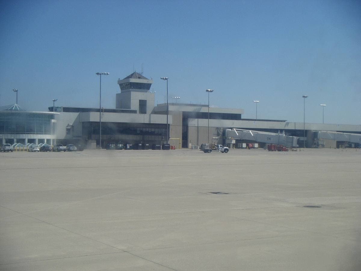 An airport terminal frontage with a drop-off lane