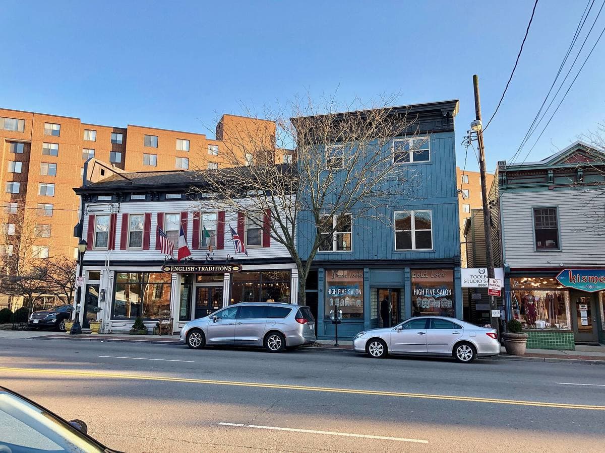 Brick shopfronts and parked cars along Madison Road