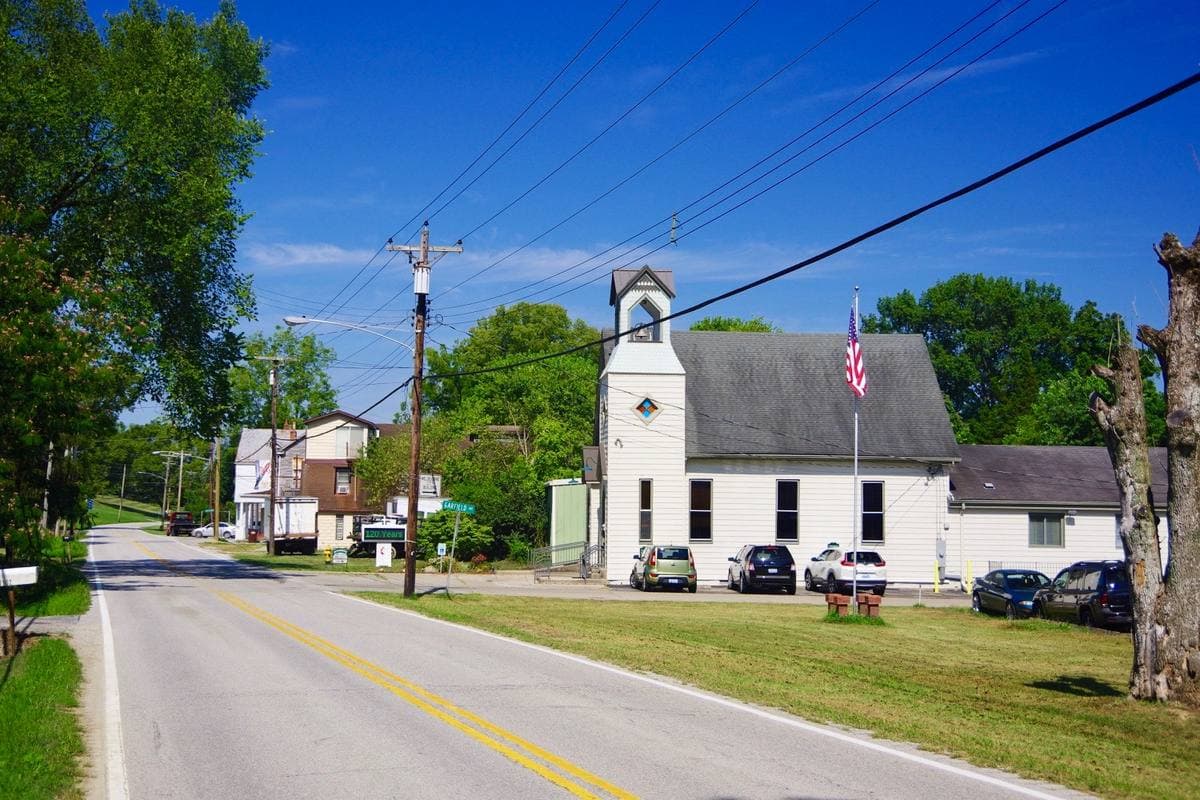 A two-lane road through the small town of Melbourne, Kentucky