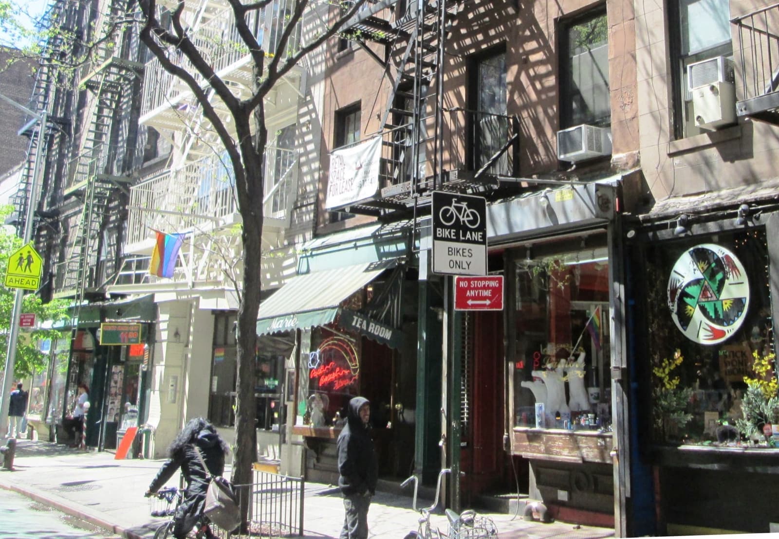 Low brick buildings with small shopfronts along Christopher Street in Greenwich Village