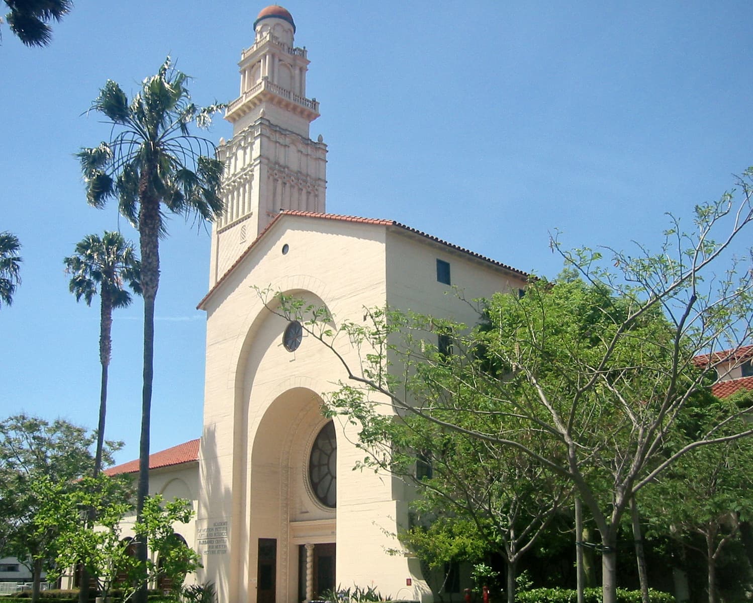 A pale Spanish-style building with a square tower on La Cienega Boulevard