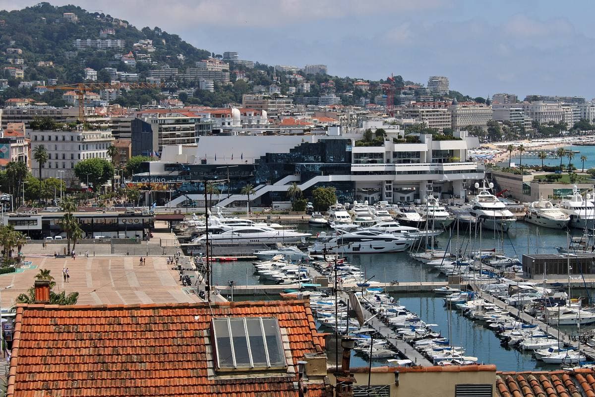 Cannes harbour full of boats, with the Palais des Festivals beyond