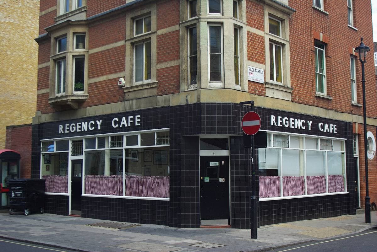 A café front in black tiles with REGENCY CAFE in white letters