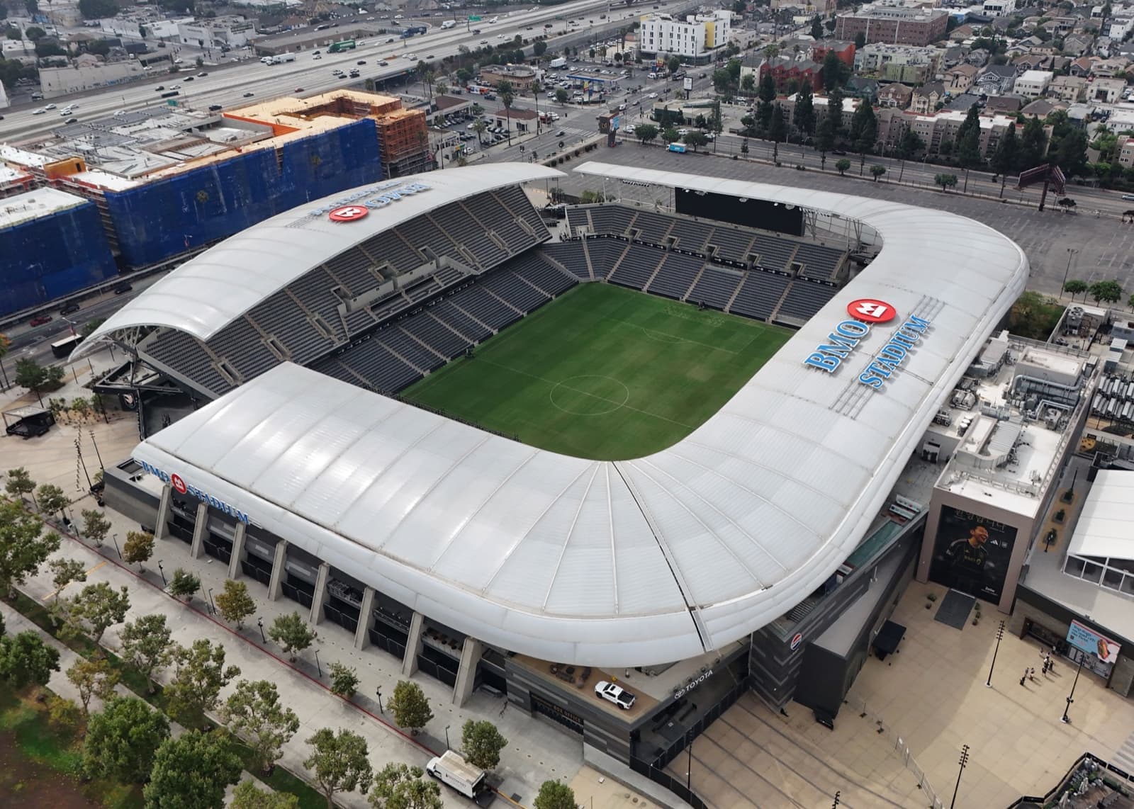 Aerial view of BMO Stadium, a white-roofed football stadium in Exposition Park