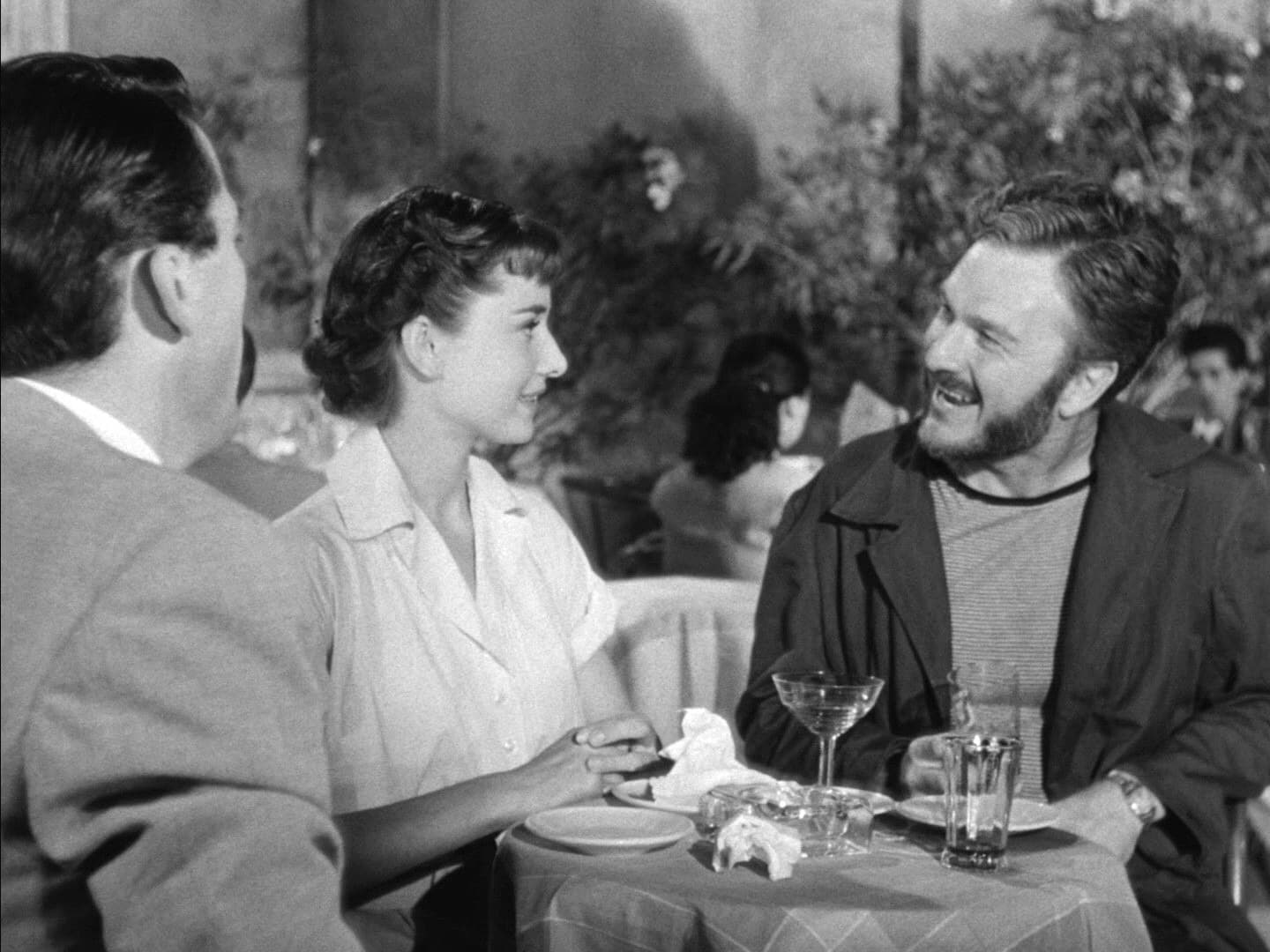 Three people at an outdoor café table