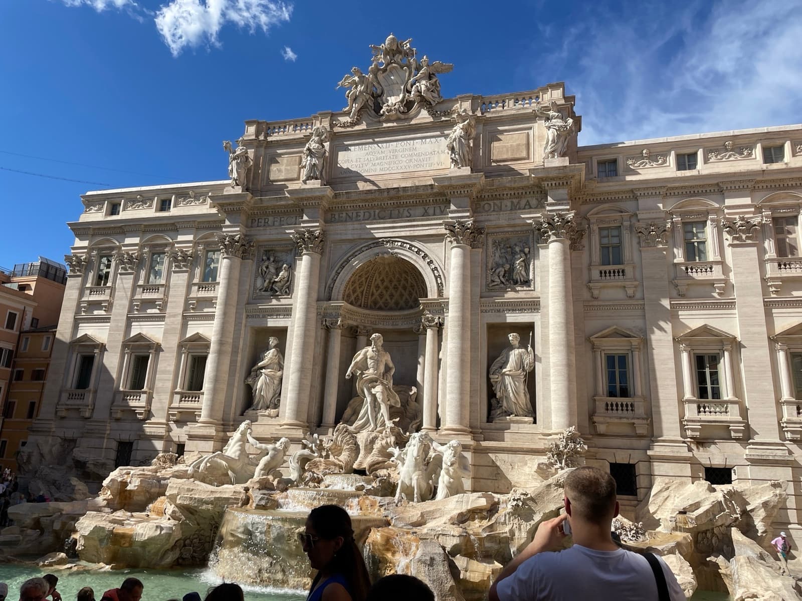 The Trevi Fountain from the front with visitors around the basin