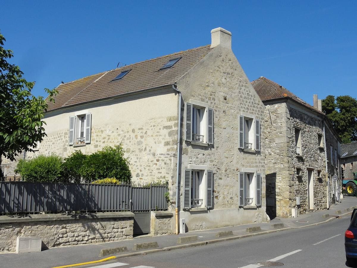 A small French village square with a stone church and old houses