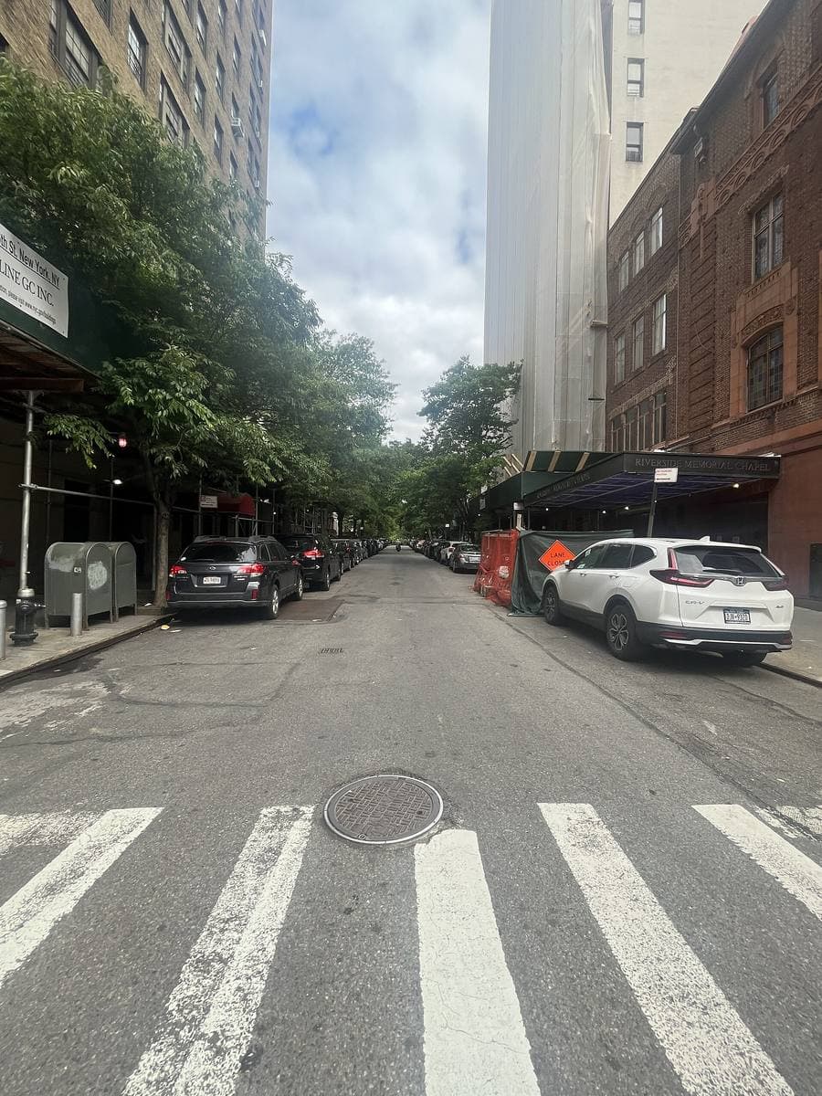 A Manhattan side street lined with brownstones and trees