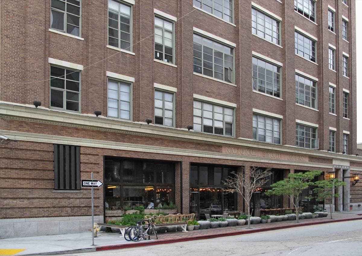 A seven-storey cream factory building on an industrial street corner