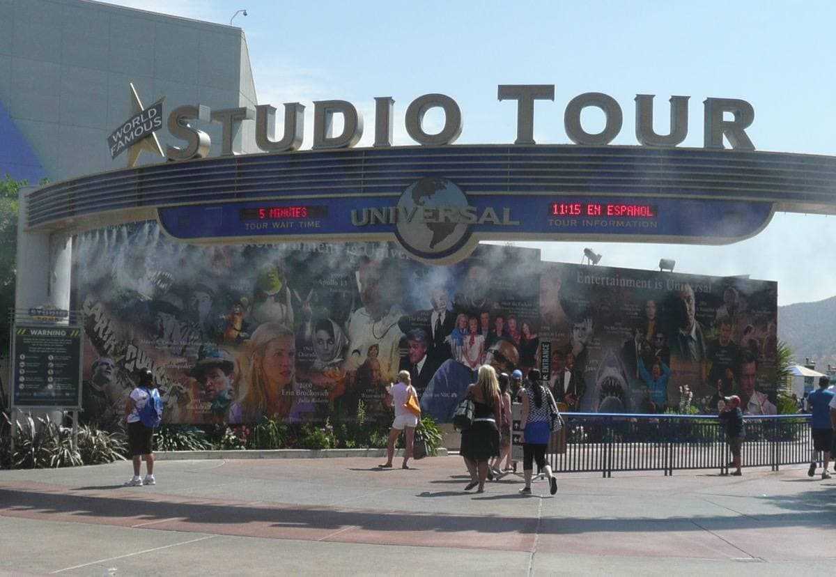 A curved arch reading Studio Tour over a crowd of visitors