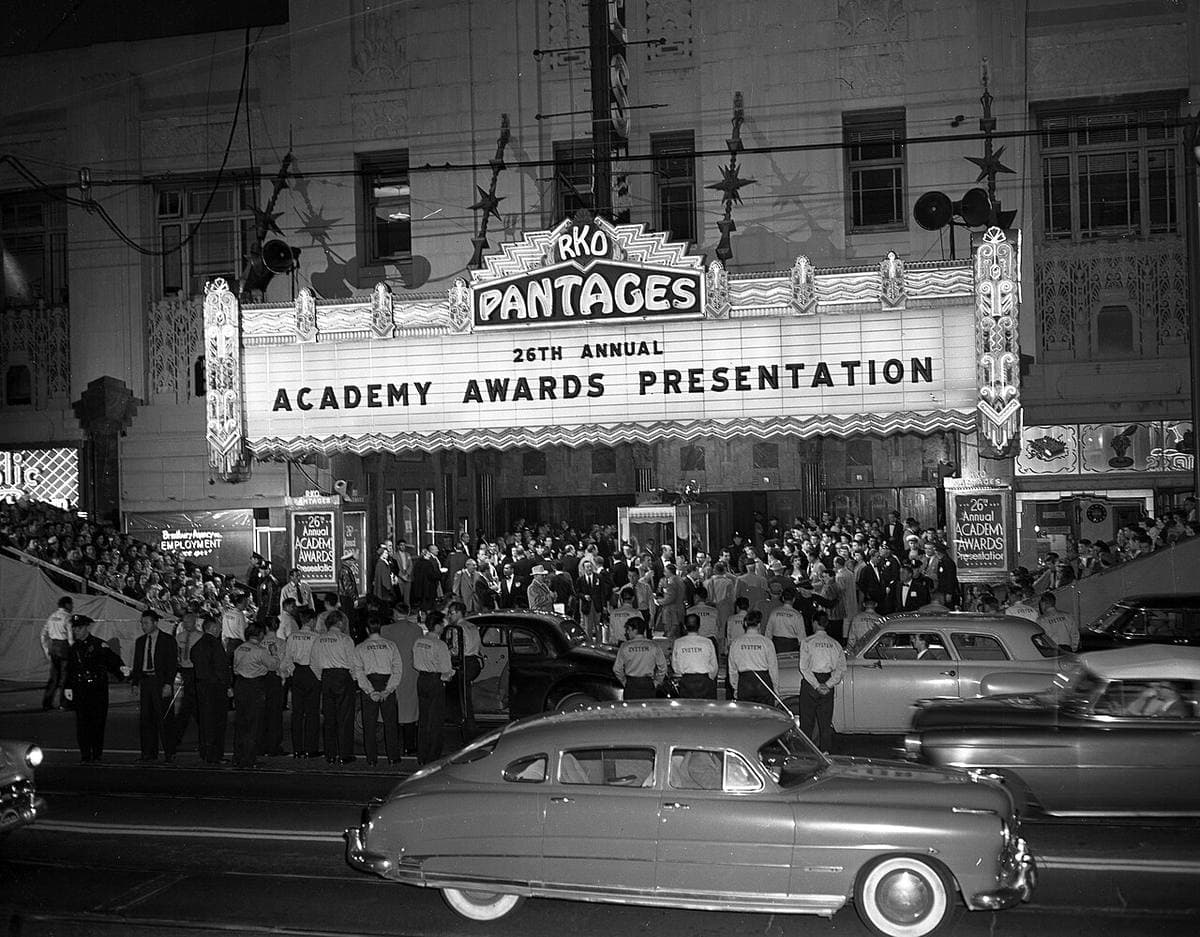 Crowds and 1950s cars under the lit RKO Pantages marquee reading Academy Awards Presentation