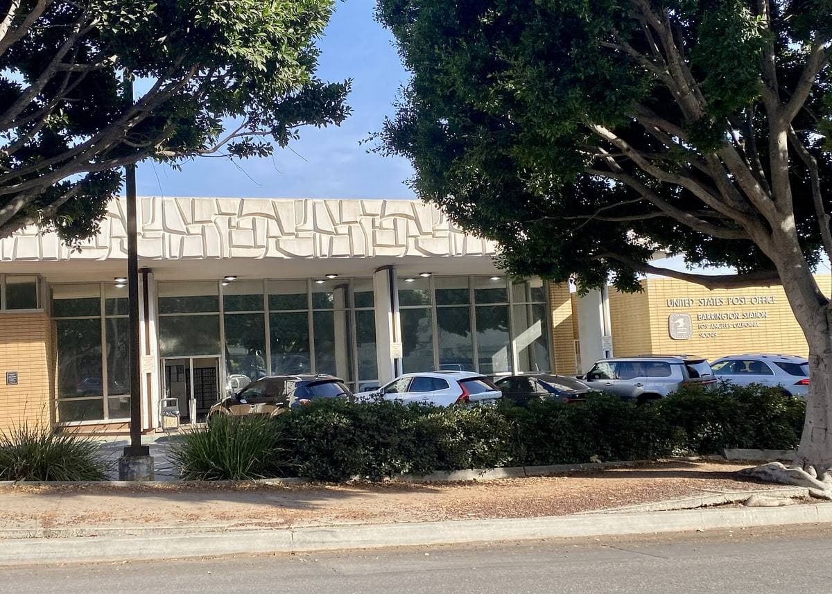 A low post-office building behind trees in Brentwood