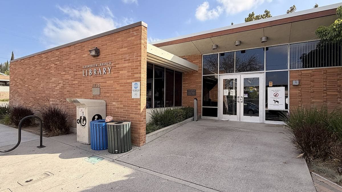 A low mid-century brick library with glass doors in Glendale