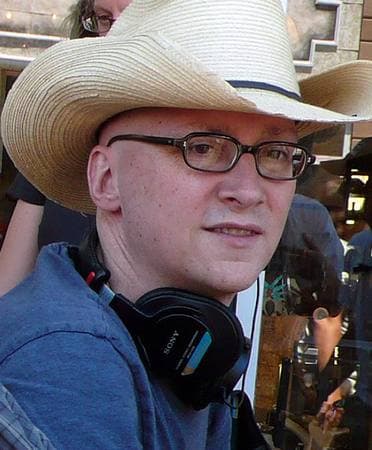 Greg Mottola in a cap on a film set