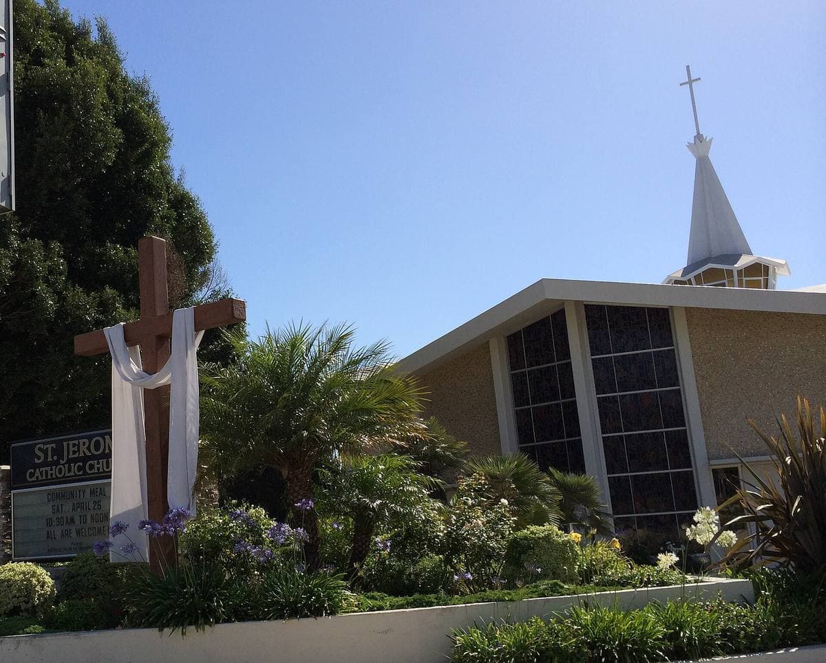 A white church with a steeple and a cross on La Tijera Boulevard