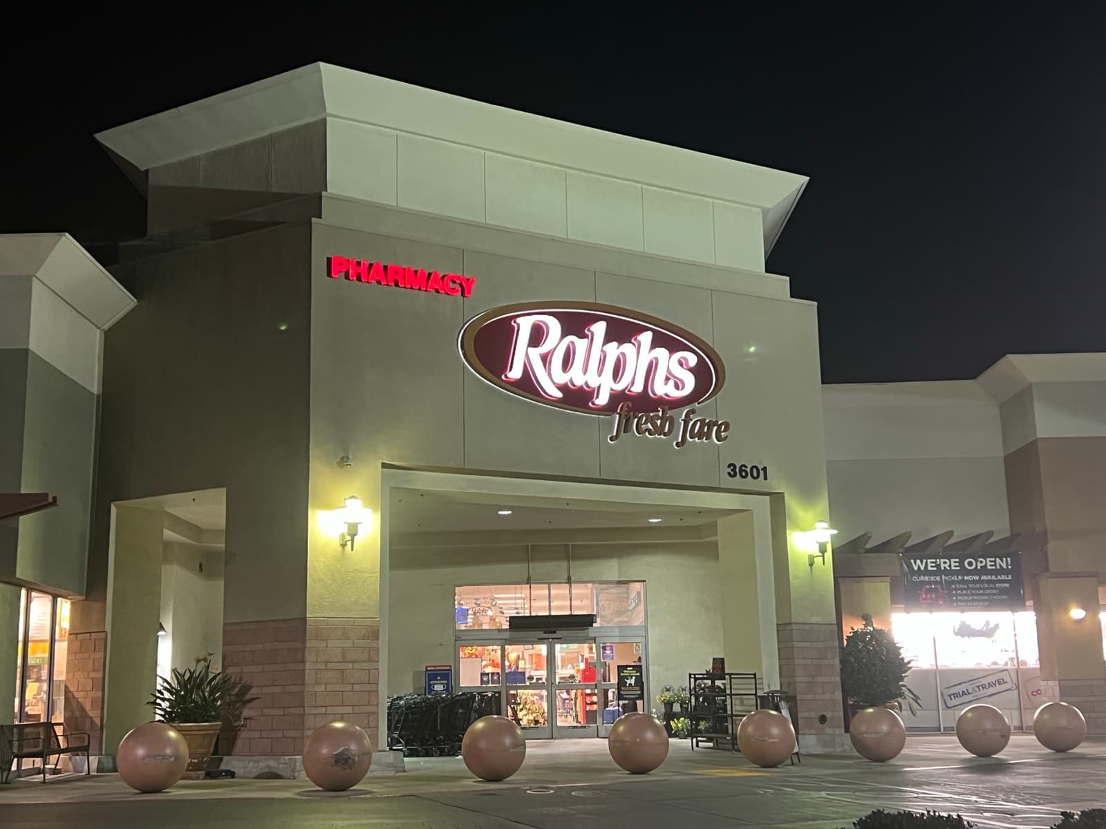 The lit front of a Ralphs supermarket at night