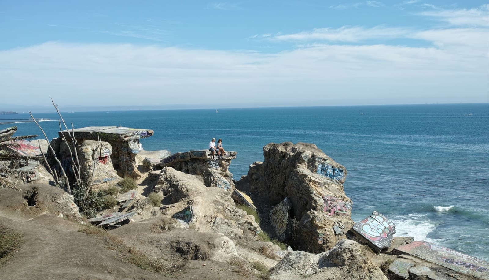 Broken slabs of old street and graffiti above the sea at Sunken City