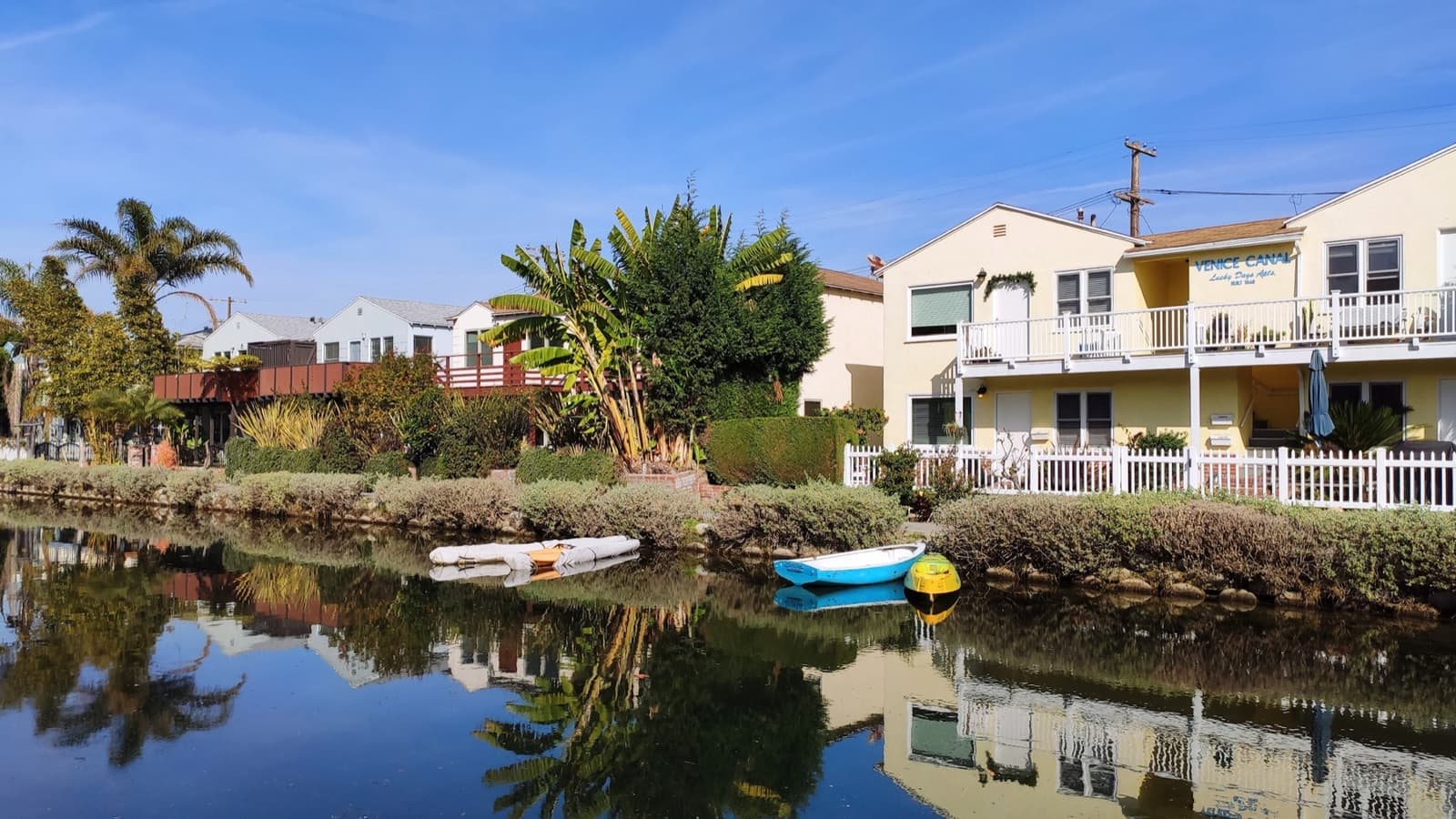 Houses and small boats reflected in a Venice canal