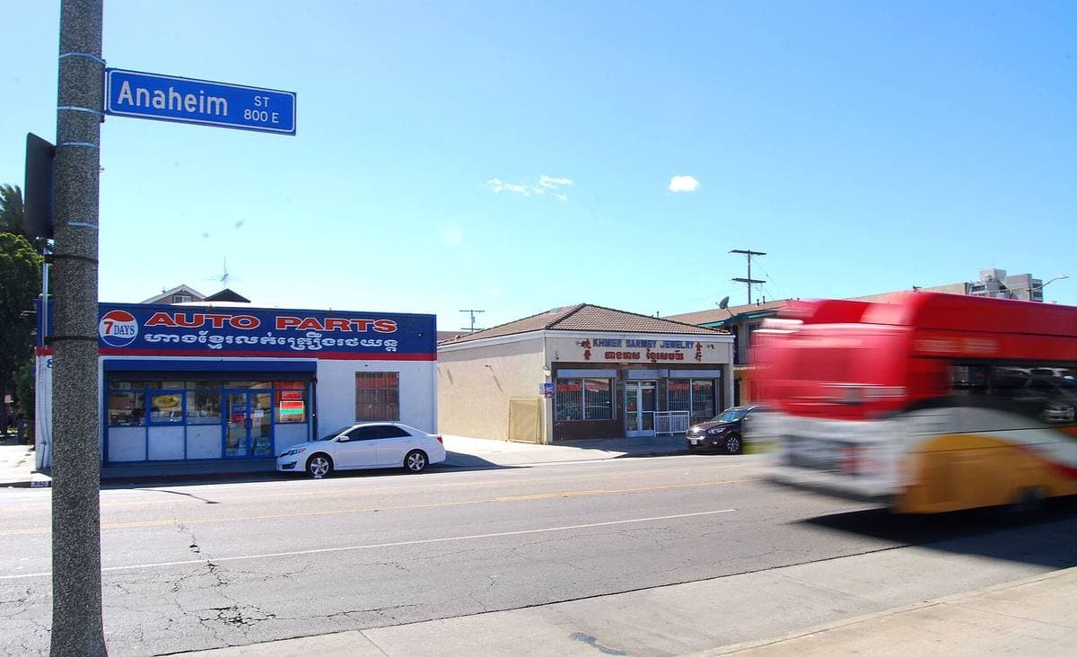 A wide street with shops and a street sign reading Anaheim