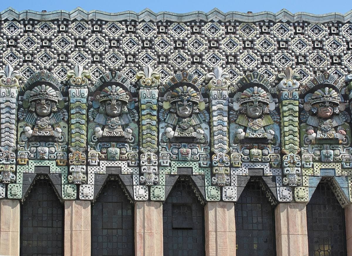 Ornate pre-Columbian style figures across a theatre facade