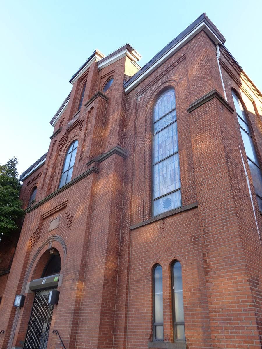 A tall red-brick church with arched windows