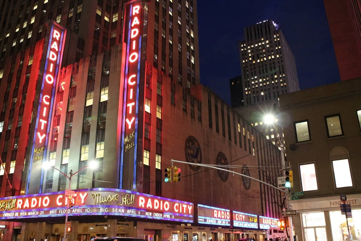 The lit Radio City Music Hall sign and marquee at night