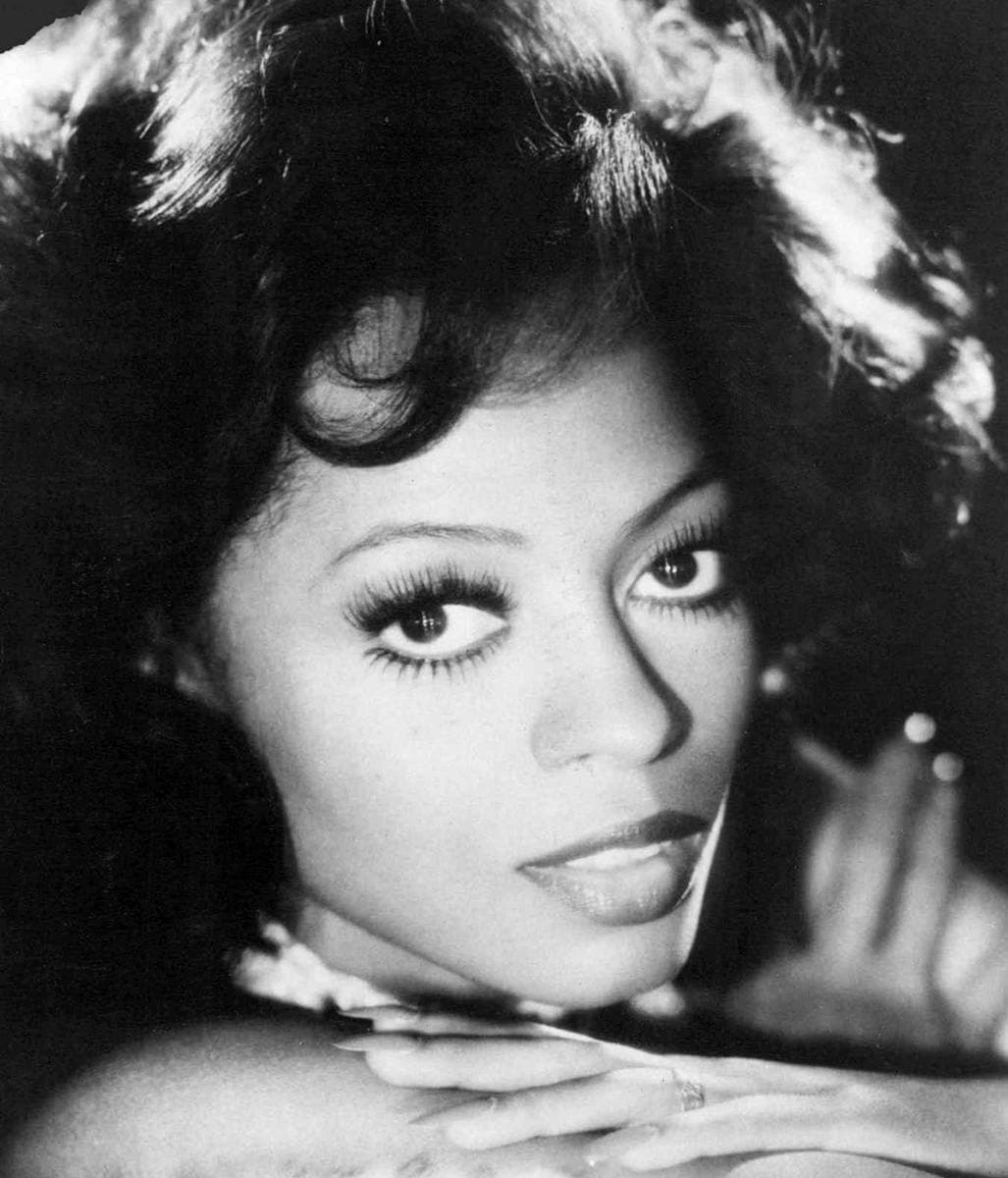 Diana Ross in a black-and-white portrait, chin resting on her hand