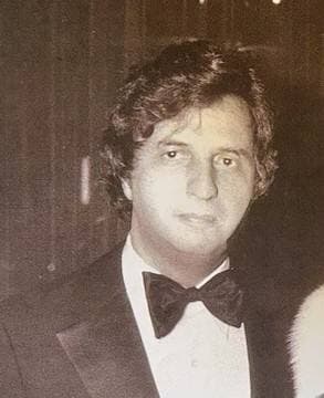 Michael Cimino in a dinner jacket and bow tie, in a sepia snapshot