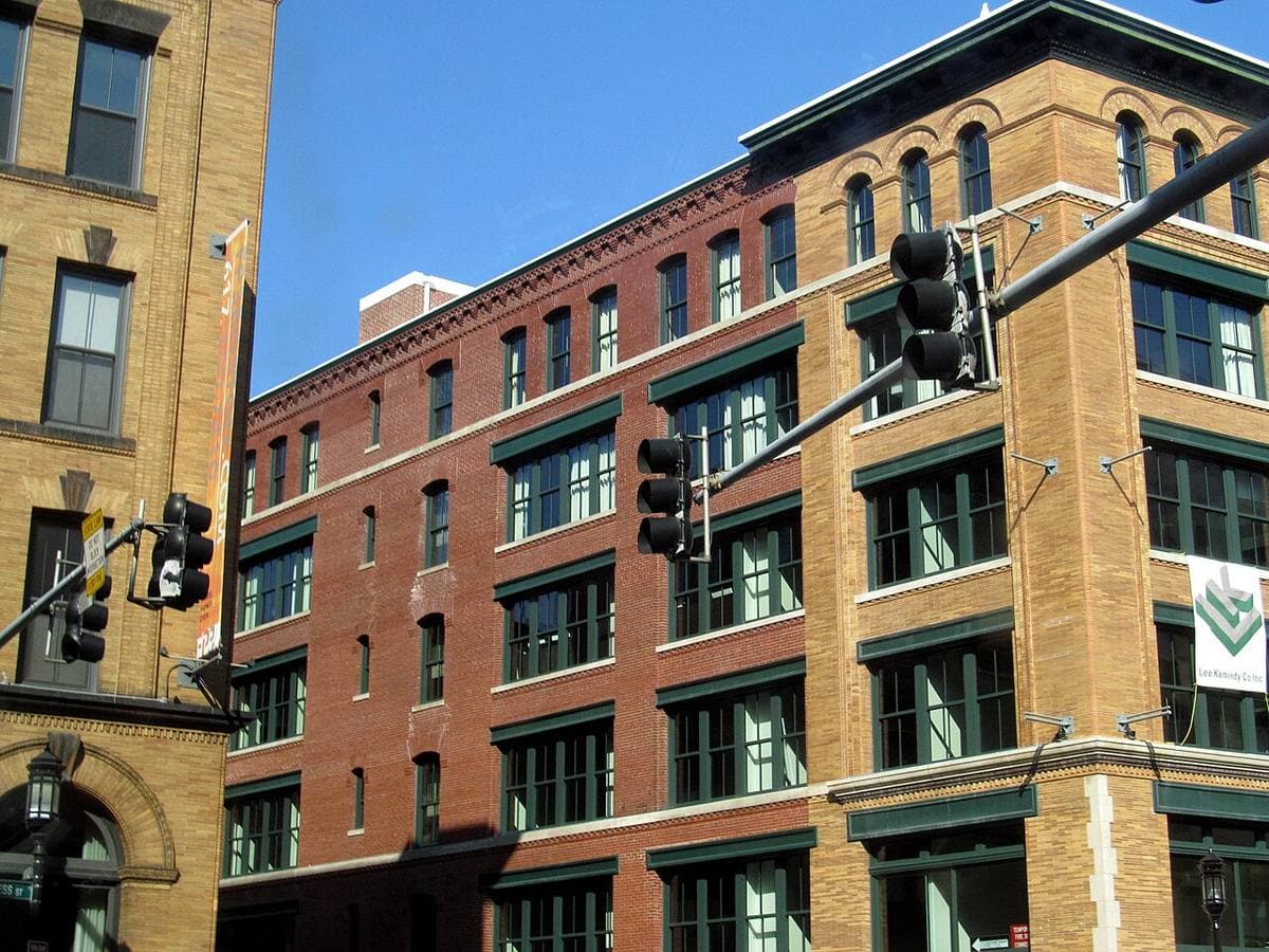 Red-brick warehouse buildings with traffic lights at a street corner