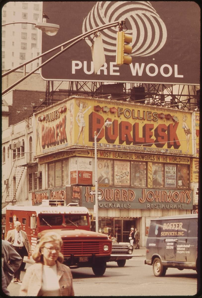 A 1973 Manhattan street corner with a Howard Johnson’s restaurant, a burlesque sign and a red truck