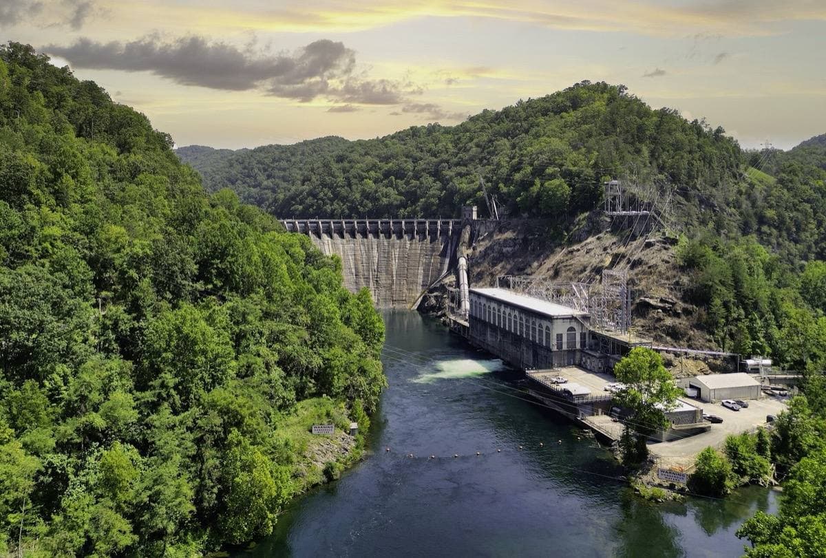 Aerial view of Cheoah Dam between wooded hills