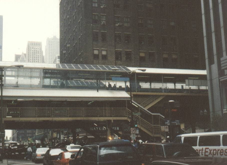 An elevated Chicago L train on its steel structure over a Loop street, 1993