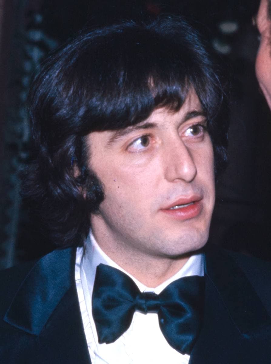 Al Pacino with long dark hair, in a dinner jacket and bow tie