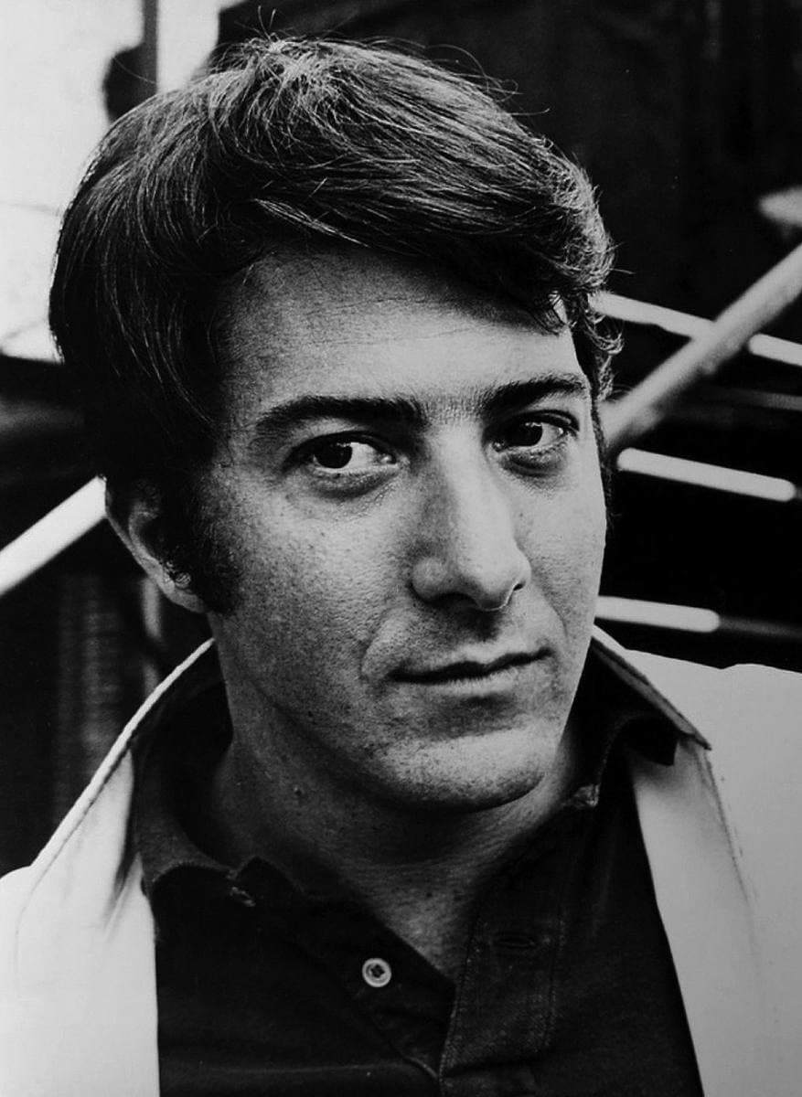 Black-and-white portrait of a young Dustin Hoffman with dark hair, looking just off camera